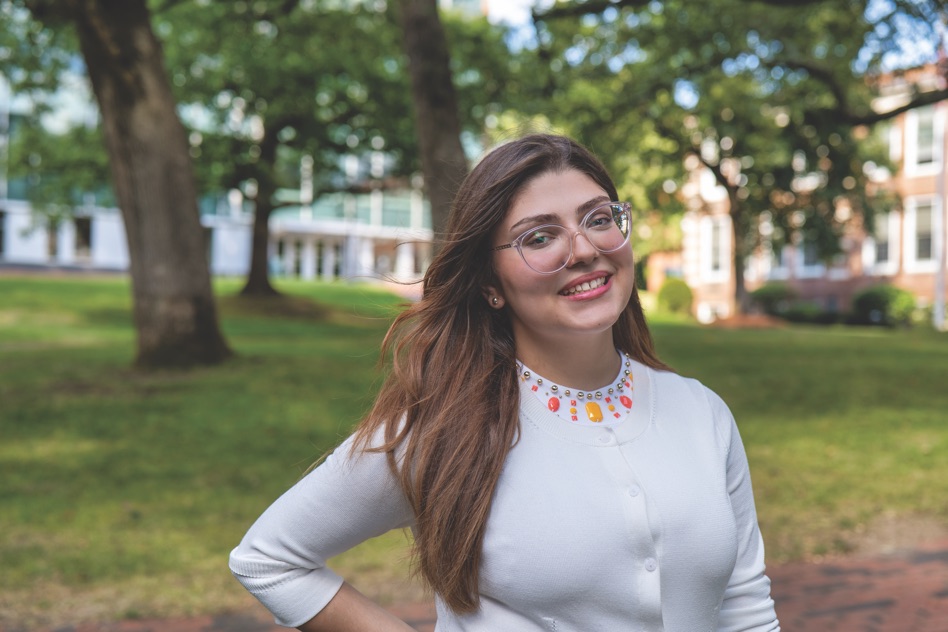 Ana Julia Ribeiro, a Pre-Med student, smiling in a portrait with long dark hair.